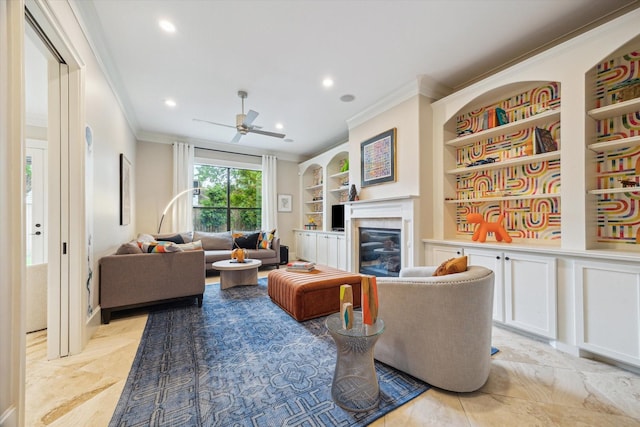 living area featuring crown molding, built in features, a glass covered fireplace, and recessed lighting