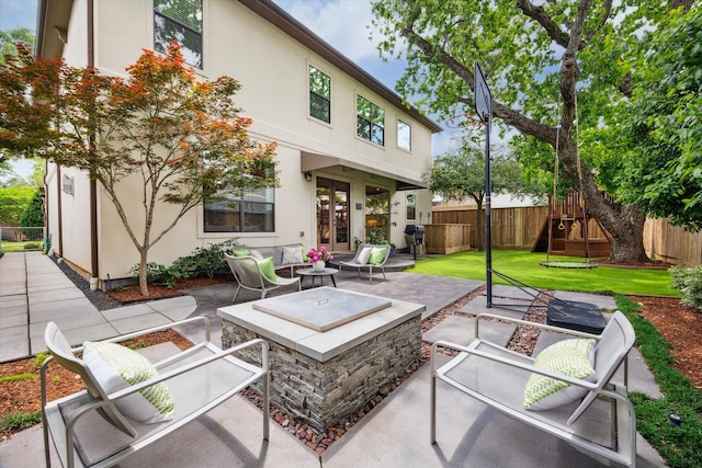 rear view of house with a fenced backyard, a playground, french doors, and an outdoor hangout area