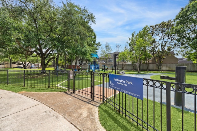 surrounding community with fence and a yard