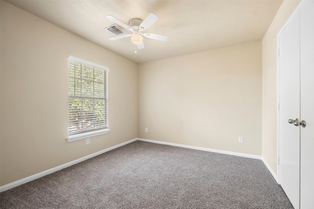 empty room with visible vents, baseboards, carpet flooring, and ceiling fan