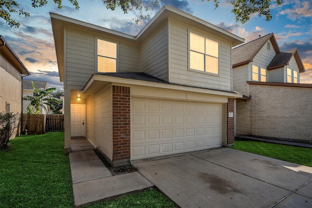 view of front of property featuring concrete driveway, fence, brick siding, a garage, and a lawn