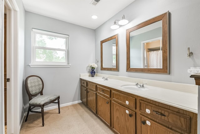 full bathroom featuring double vanity, visible vents, and a sink