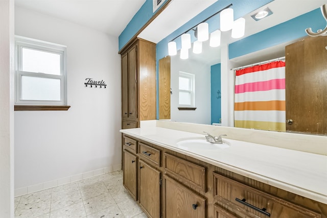 full bathroom with vanity, baseboards, and a shower with curtain