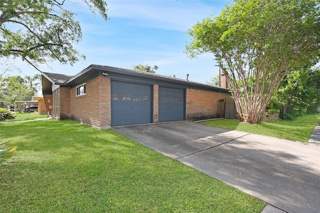 view of side of property featuring driveway, a chimney, brick siding, an attached garage, and a yard
