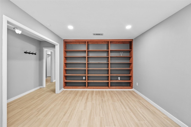 below grade area with recessed lighting, light wood-type flooring, visible vents, and baseboards