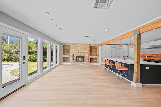 unfurnished sunroom with visible vents and a sink