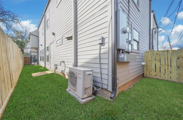 view of home's exterior with a fenced backyard, ac unit, and a yard