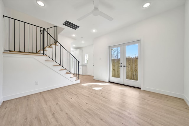 unfurnished living room with a ceiling fan, wood finished floors, french doors, baseboards, and visible vents