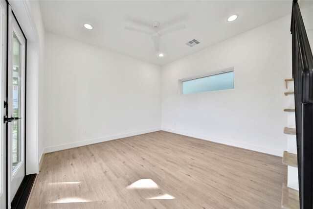 empty room with recessed lighting, wood finished floors, visible vents, and a healthy amount of sunlight