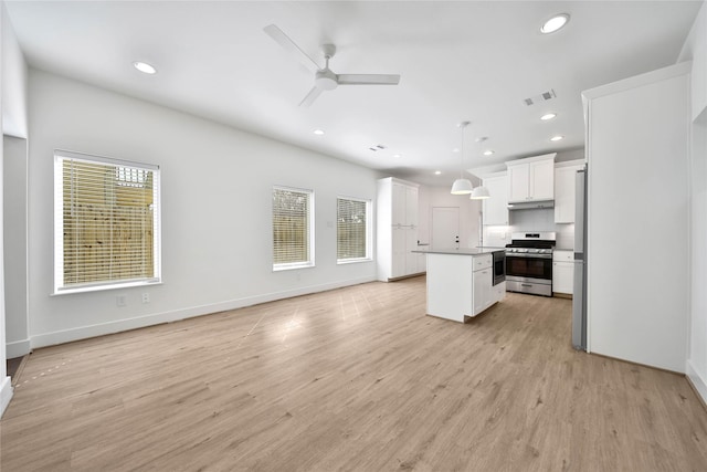 unfurnished living room with visible vents, baseboards, recessed lighting, light wood-style floors, and a ceiling fan