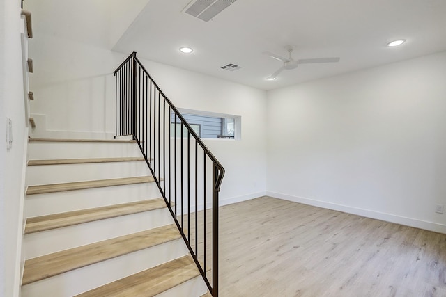staircase with wood finished floors, a ceiling fan, visible vents, and recessed lighting