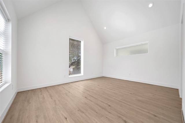 unfurnished room with vaulted ceiling, a healthy amount of sunlight, light wood-style floors, and recessed lighting