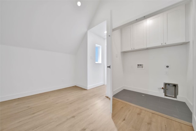 laundry area with light wood-type flooring, hookup for a gas dryer, hookup for a washing machine, electric dryer hookup, and cabinet space
