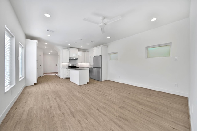 7407 Rusk St Unit B, Houston, TX 77011 - kitchen featuring stainless steel appliances, open floor plan, a ceiling fan, under cabinet range hood, and a kitchen island