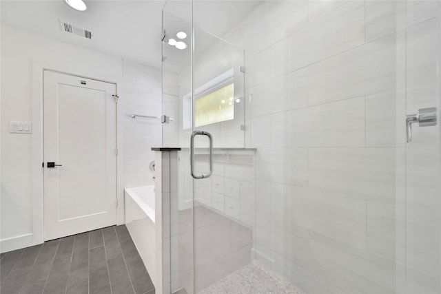 7407 Rusk St Unit B, Houston, TX 77011 - full bathroom featuring a shower stall, visible vents, and a tub