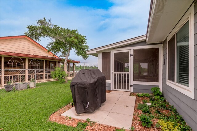 view of yard featuring a patio area and a sunroom