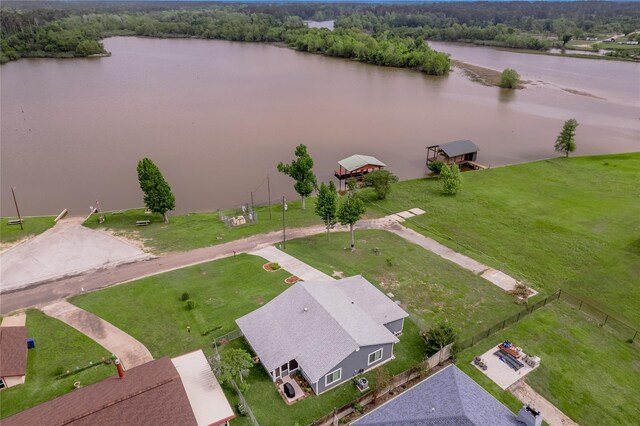 birds eye view of property with a water view and a forest view