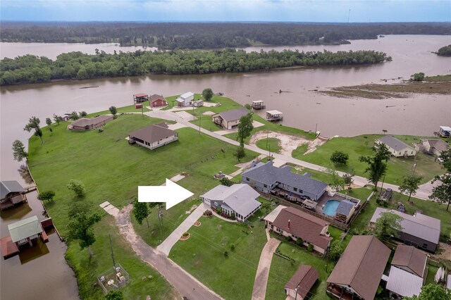 aerial view with a wooded view, a water view, and a residential view