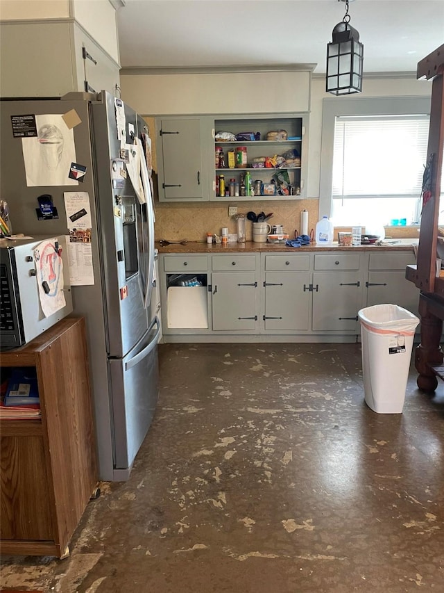 kitchen featuring open shelves, decorative light fixtures, and stainless steel refrigerator with ice dispenser