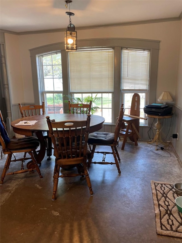 dining area with ornamental molding and finished concrete floors