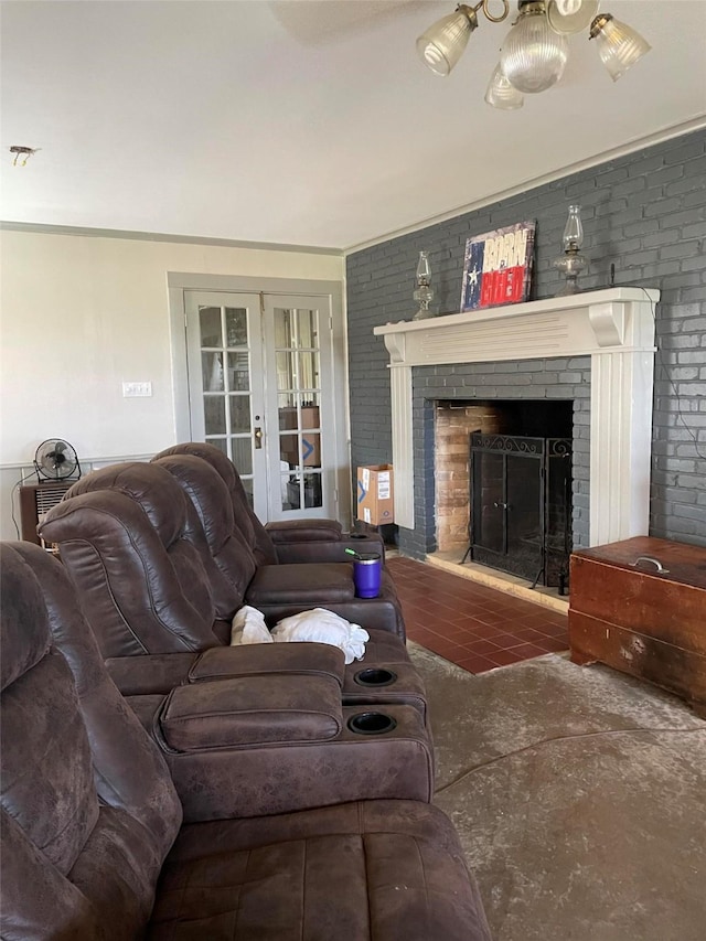 living area featuring a fireplace, brick wall, and french doors