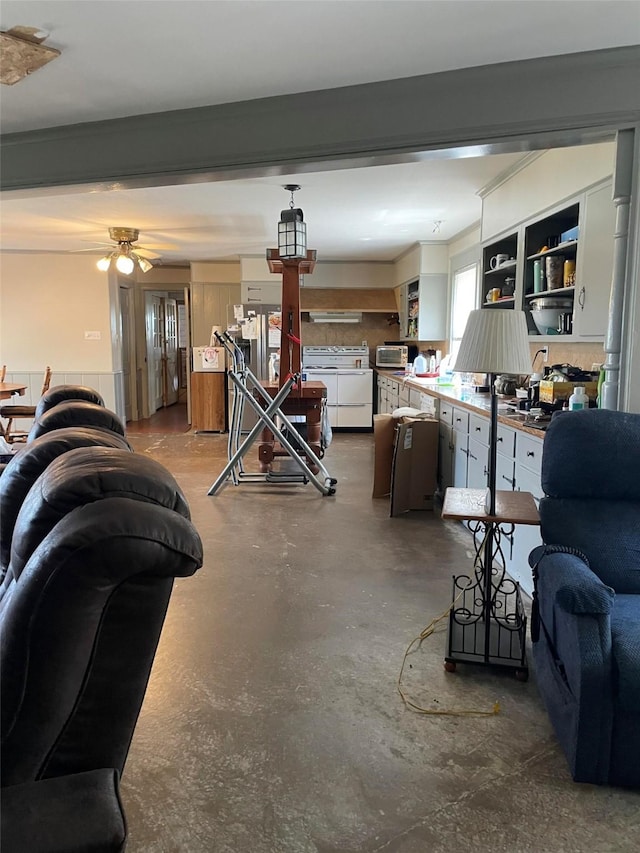 interior space with concrete flooring, a healthy amount of sunlight, and ceiling fan