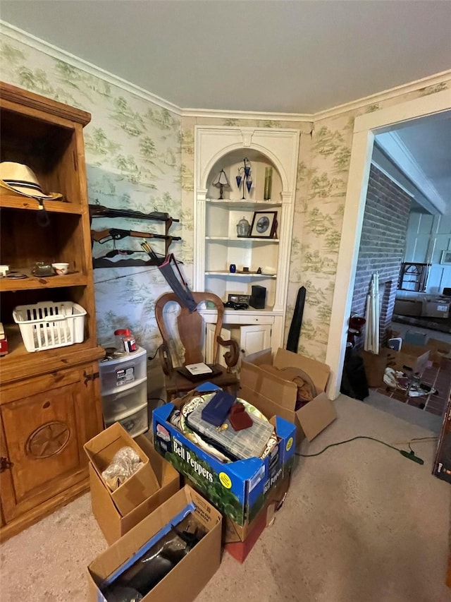dining area with ornamental molding and wallpapered walls