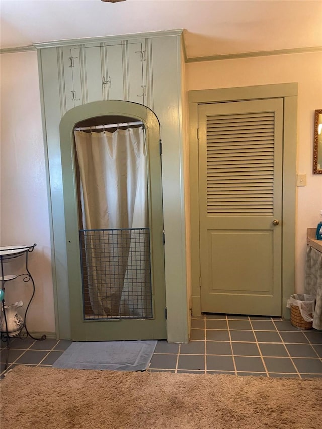 doorway to outside with carpet floors and tile patterned flooring
