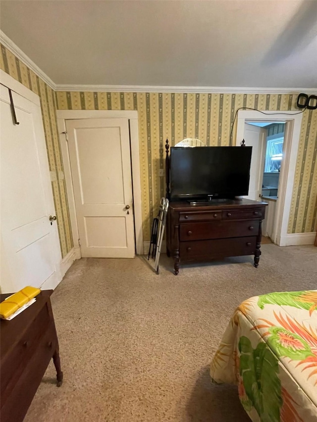 carpeted bedroom featuring wallpapered walls, baseboards, and ornamental molding
