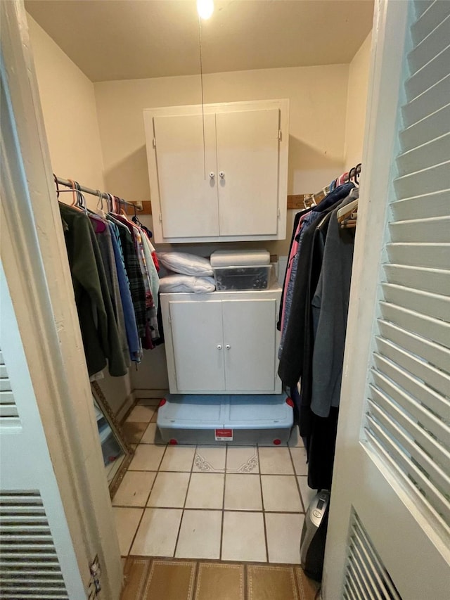 clothes washing area featuring light tile patterned flooring and laundry area