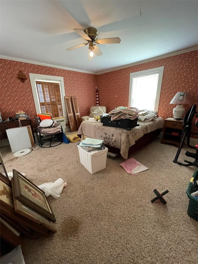 bedroom with wallpapered walls, carpet floors, ceiling fan, and ornamental molding