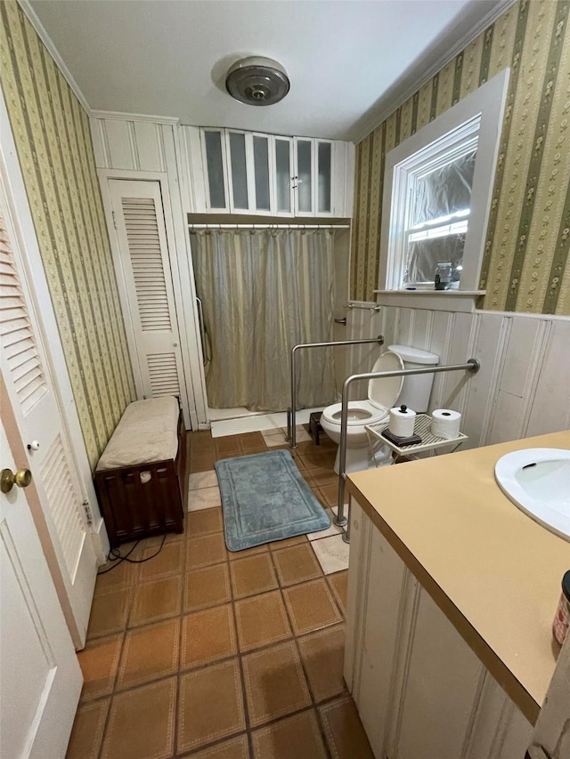 full bathroom with curtained shower, wallpapered walls, tile patterned flooring, toilet, and vanity