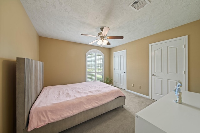 1704 Tempe St, League City, TX 77573 - carpeted bedroom with a textured ceiling, baseboards, and ceiling fan