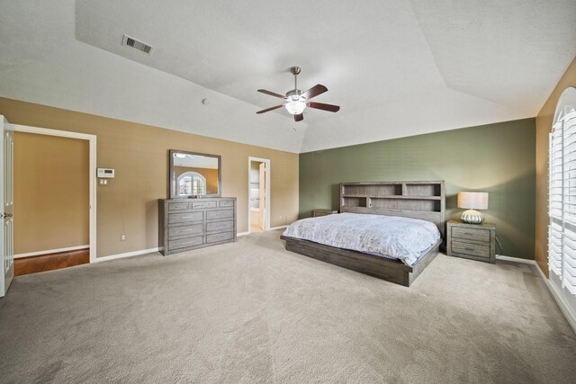 1704 Tempe St, League City, TX 77573 - carpeted bedroom featuring vaulted ceiling, baseboards, a ceiling fan, and connected bathroom