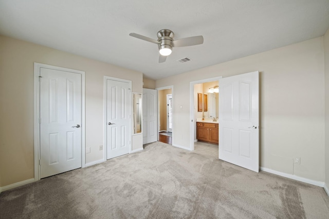 1704 Tempe St, League City, TX 77573 - unfurnished bedroom with multiple closets, light carpet, baseboards, and connected bathroom