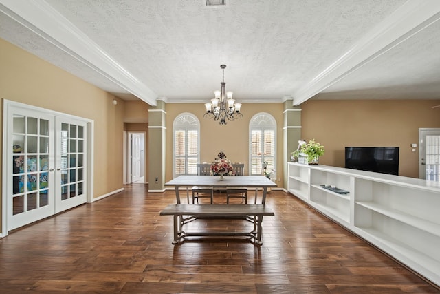 1704 Tempe St, League City, TX 77573 - dining room with a textured ceiling, a chandelier, french doors, wood finished floors, and decorative columns