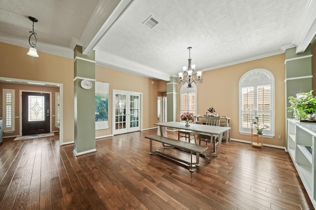 1704 Tempe St, League City, TX 77573 - dining area with a chandelier, dark wood finished floors, ornamental molding, a textured ceiling, and baseboards