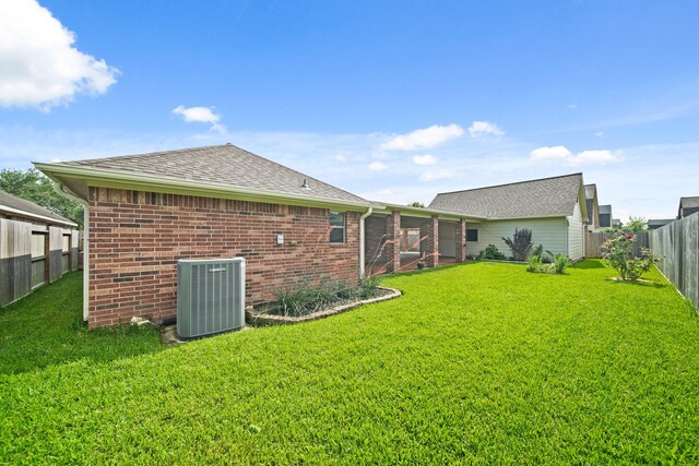 1704 Tempe St, League City, TX 77573 - back of property featuring central air condition unit, brick siding, and a shingled roof