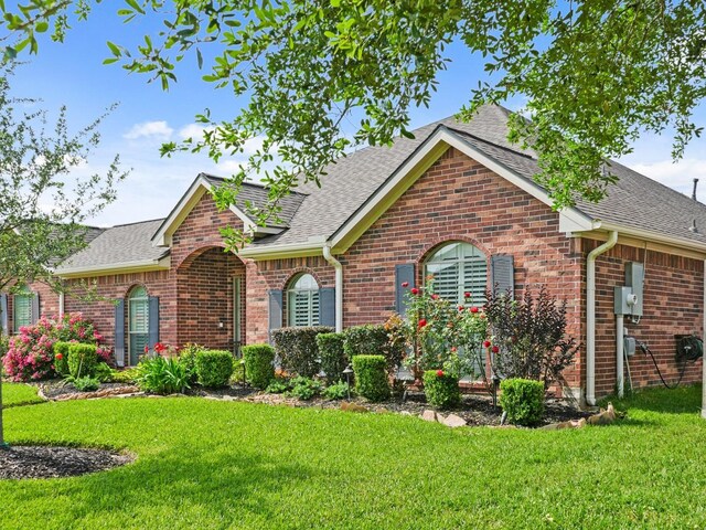 1704 Tempe St, League City, TX 77573 - ranch-style home featuring brick siding, a front lawn, and a shingled roof