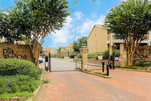 view of gate featuring a residential view and fence
