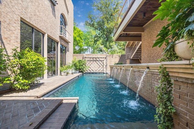 view of pool with a fenced in pool and fence
