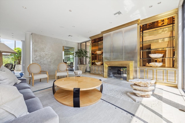 living area with recessed lighting, visible vents, and a glass covered fireplace