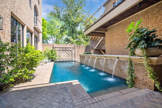 pool with fence and a patio area