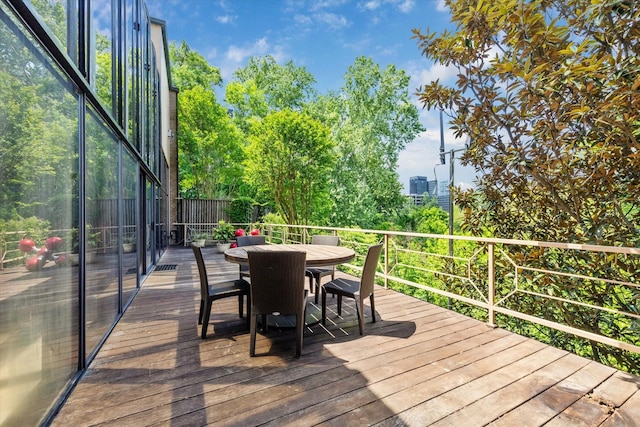 wooden deck featuring outdoor dining area
