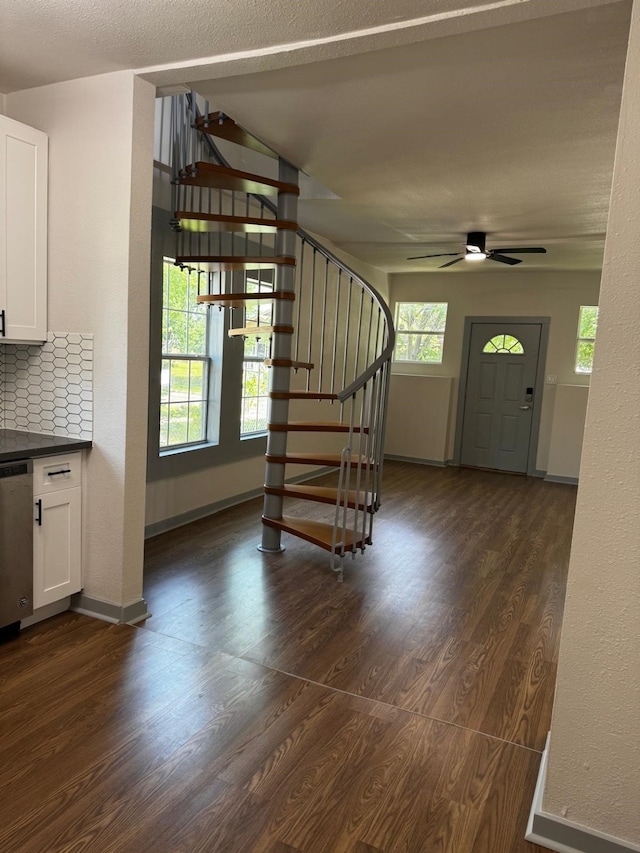 3401 Illinois St, Baytown, TX 77520 - interior space featuring stairway, ceiling fan, baseboards, and dark wood-style flooring