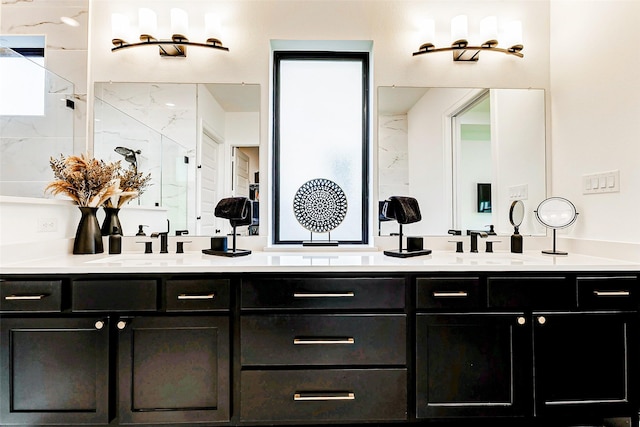 bathroom featuring double vanity, a sink, and a marble finish shower