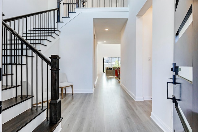 foyer entrance featuring stairs, recessed lighting, baseboards, and wood finished floors