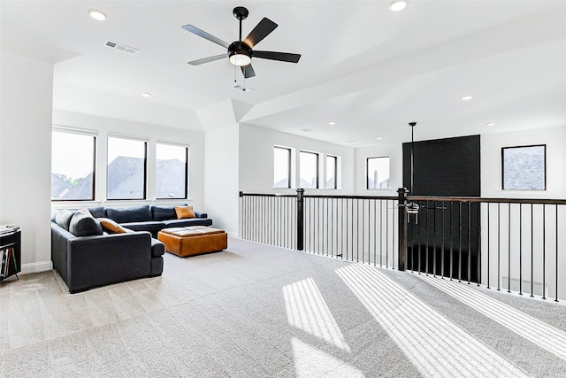 living room with visible vents, recessed lighting, and light colored carpet