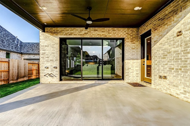 view of patio with fence and a ceiling fan