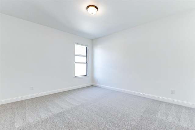 empty room with carpet flooring and baseboards